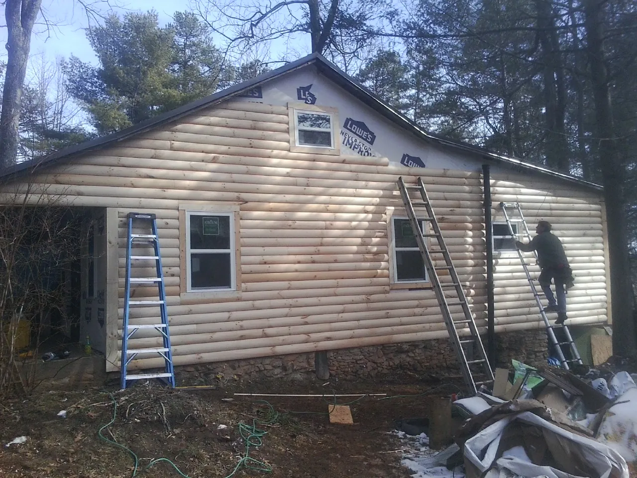 Ladders set against fresh log siding during an exterior remodel in Texarkana