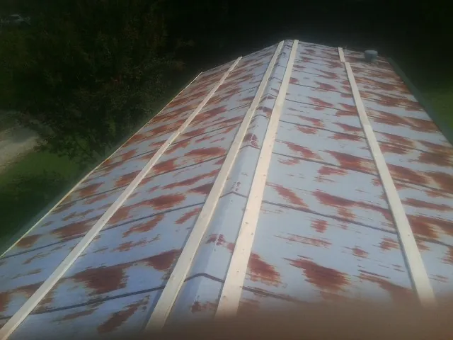 Rusted metal roof panels with new wood purlins before replacement — Storm Damage Roof Repair in Texarkana by Roofing Brothers